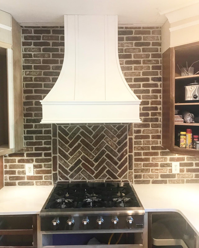 Kitchen stove and fan, brick backsplash